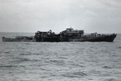 USS Belknap adrift at sea in daylight after the fire, upper superstructure collapsed and gutted.