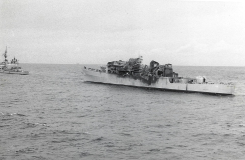 USS Belknap seen from a rescuing ship the morning after, superstructure destroyed, another U.S. Navy warship standing by.
